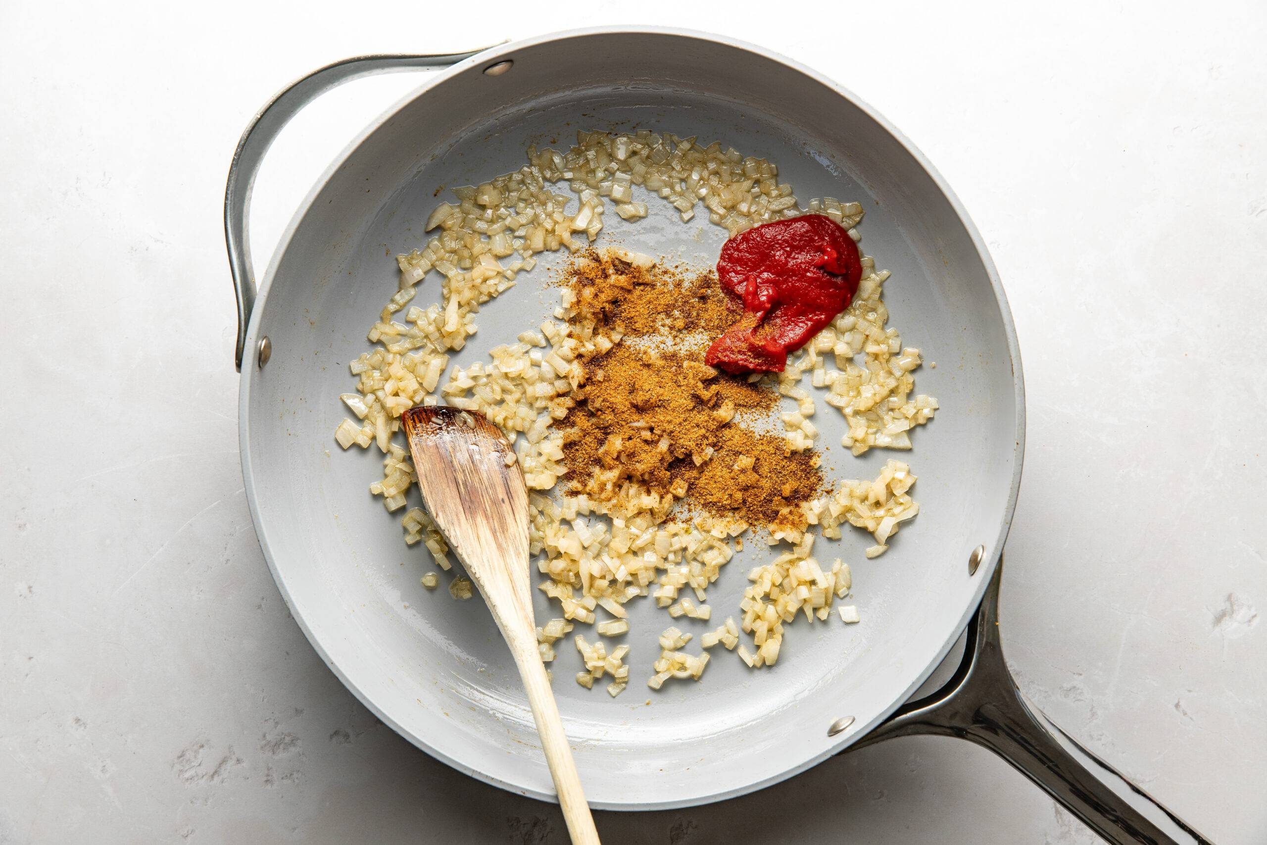 Shallots and spices in a skillet.