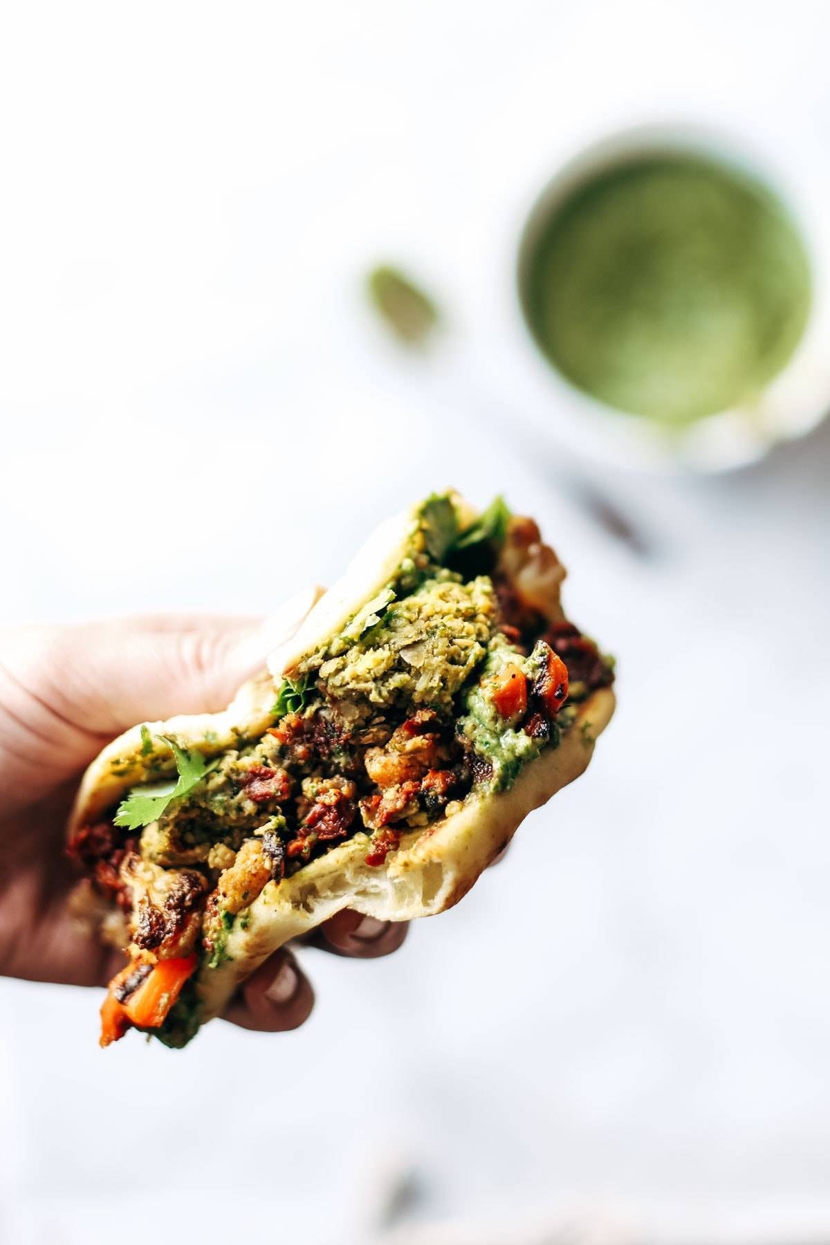 Naan-wich: 5 ingredient falafel, roasted veggies, and avocado sauce stuffed between pillowy garlic naan. Best sandwich recipe I've ever made. | pinchofyum.com